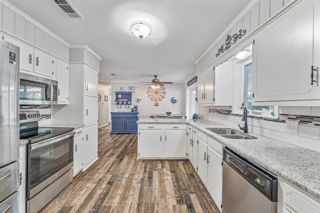 a large kitchen with a stove top oven