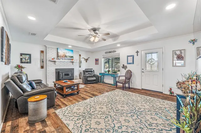 a living room with furniture a fireplace and a table