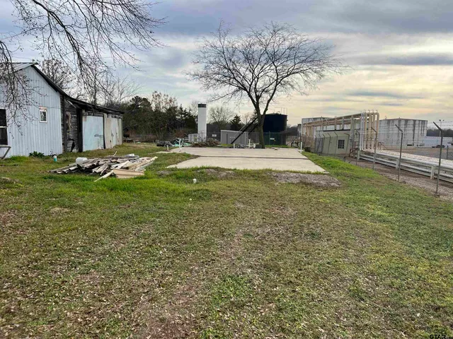 a view of a yard with table and chairs and a fire pit