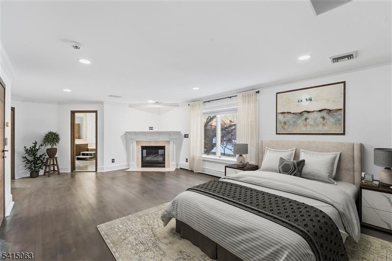 99 Ogle Road Old Tappan, NJ 07675 - Photo 13 of 35 a spacious bedroom with a large bed and a fireplace