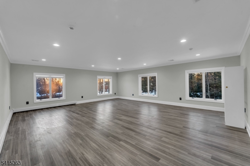 99 Ogle Road Old Tappan, NJ 07675 - Photo 14 of 35 an empty room with wooden floor and windows