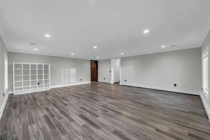 99 Ogle Road Old Tappan, NJ 07675 - Photo 15 of 35 an empty room with wooden floor and windows