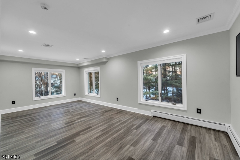 99 Ogle Road Old Tappan, NJ 07675 - Photo 16 of 35 a view of an empty room with wooden floor and a window
