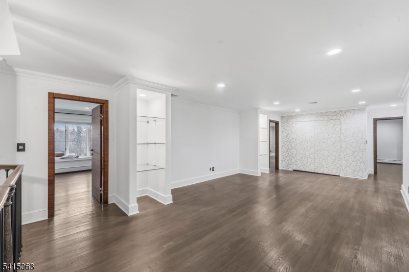 99 Ogle Road Old Tappan, NJ 07675 - Photo 17 of 35 a view of an empty room with wooden floor and a cabinet