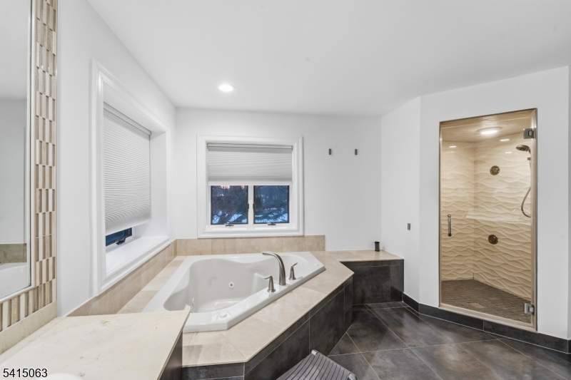 99 Ogle Road Old Tappan, NJ 07675 - Photo 21 of 35 a bathroom with a granite countertop tub shower and sink