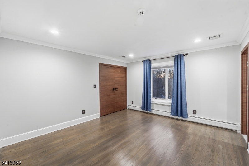 99 Ogle Road Old Tappan, NJ 07675 - Photo 26 of 35 a view of an empty room with wooden floor