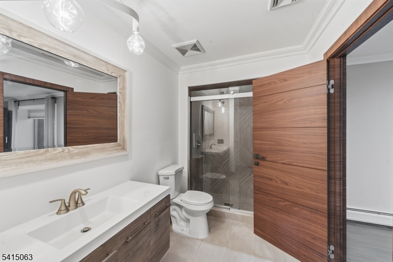 99 Ogle Road Old Tappan, NJ 07675 - Photo 34 of 35 a bathroom with a sink a toilet and shower