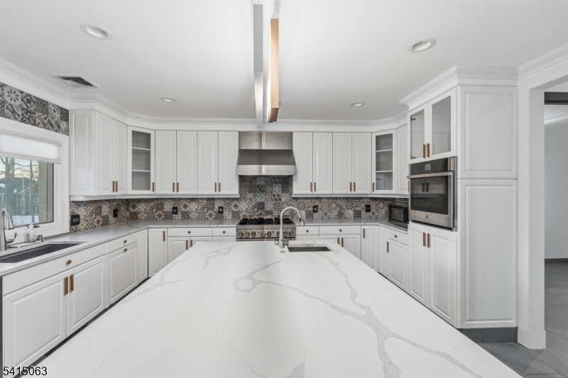 99 Ogle Road Old Tappan, NJ 07675 - Photo 9 of 35 a kitchen with a sink stove and cabinets