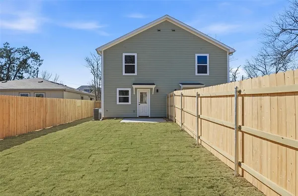 a front view of a house with wooden fence