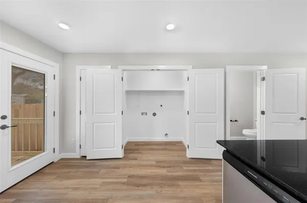 a view of a kitchen with white cabinets