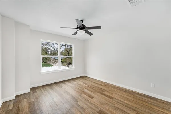 wooden floor in an empty room with a window
