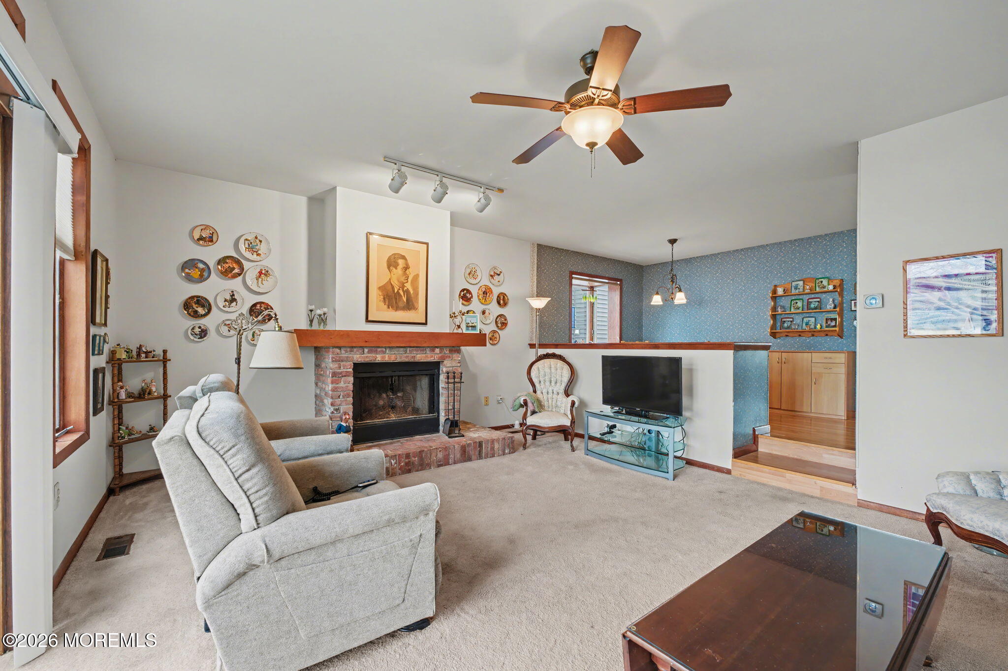 813 West Laurel Avenue Point Pleasant Beach, NJ 08742 - Photo 25 of 32 a living room with furniture a fireplace and a flat screen tv