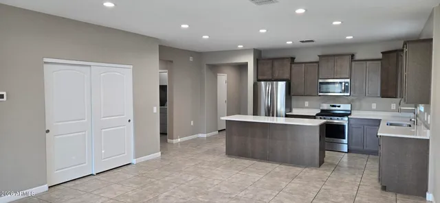 a kitchen with stainless steel appliances granite countertop a refrigerator oven a sink and dishwasher