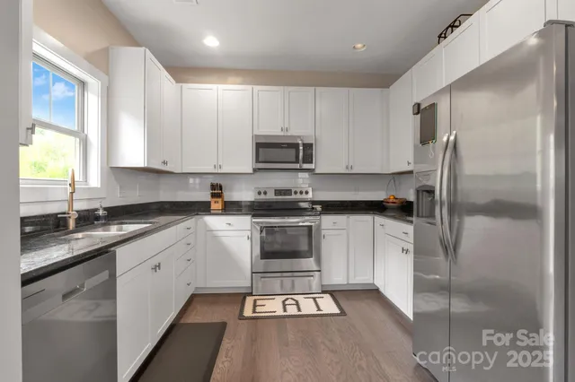 a kitchen with a refrigerator and a stove