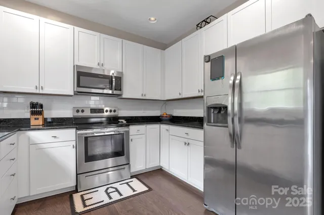 a kitchen with cabinets and stainless steel appliances
