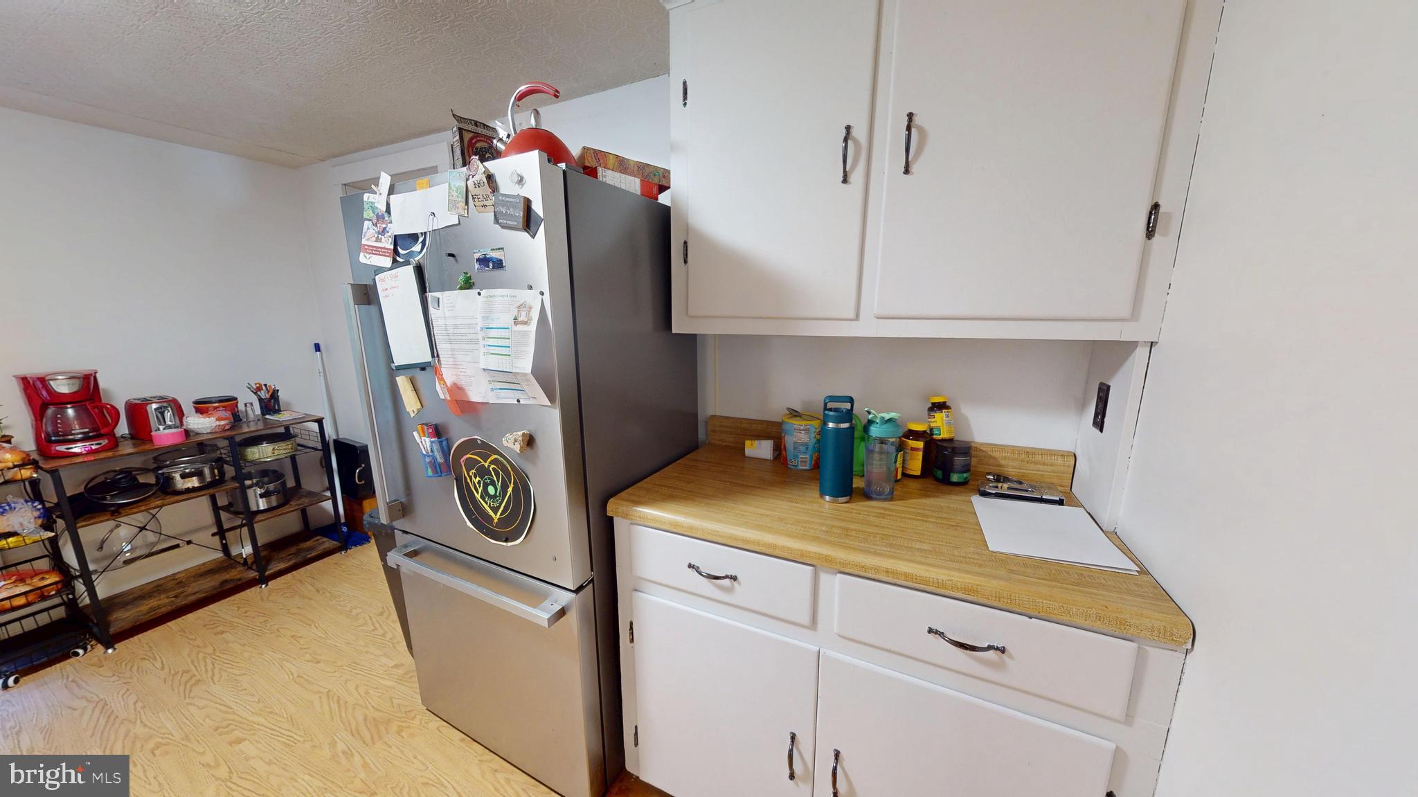 71 Woodbine Road Lewistown, PA 17044 - Photo 23 of 44 a kitchen with cabinets and a refrigerator