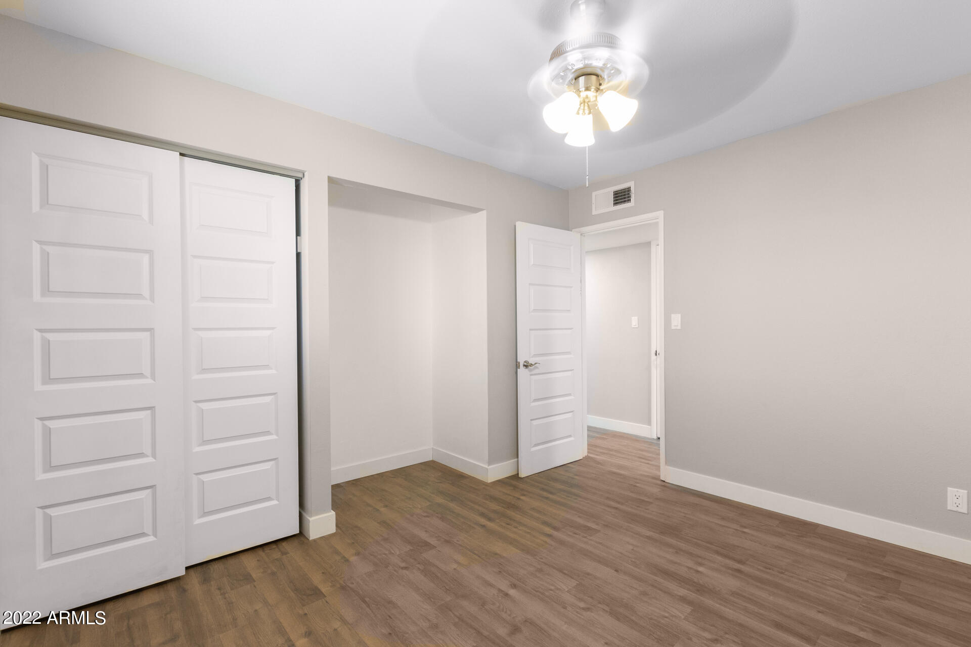 1036 East Butler Drive Phoenix, AZ 85020 - Photo 13 of 25 wooden floor in an empty room with a window