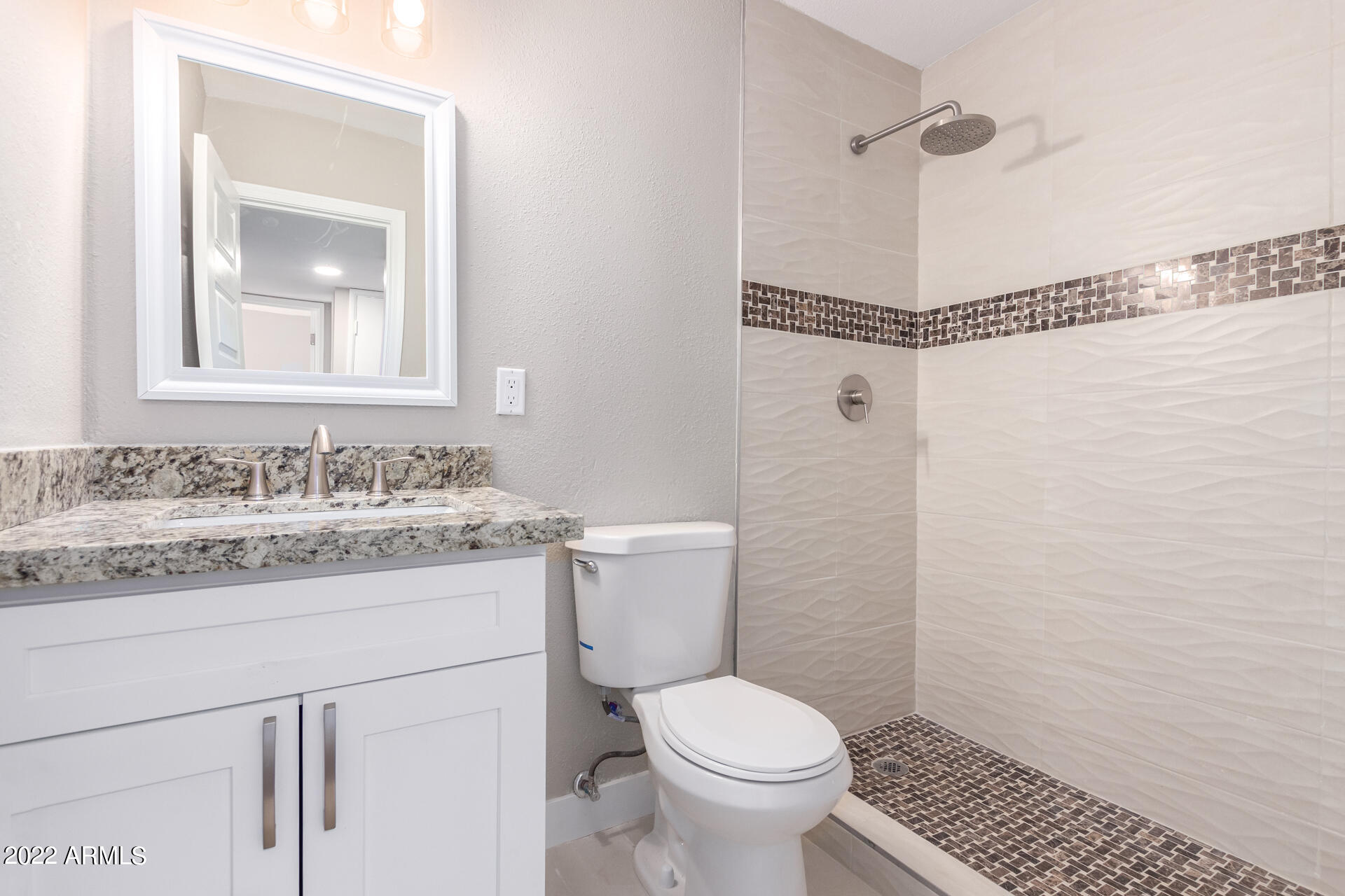 1036 East Butler Drive Phoenix, AZ 85020 - Photo 16 of 25 a bathroom with a granite countertop sink toilet and shower