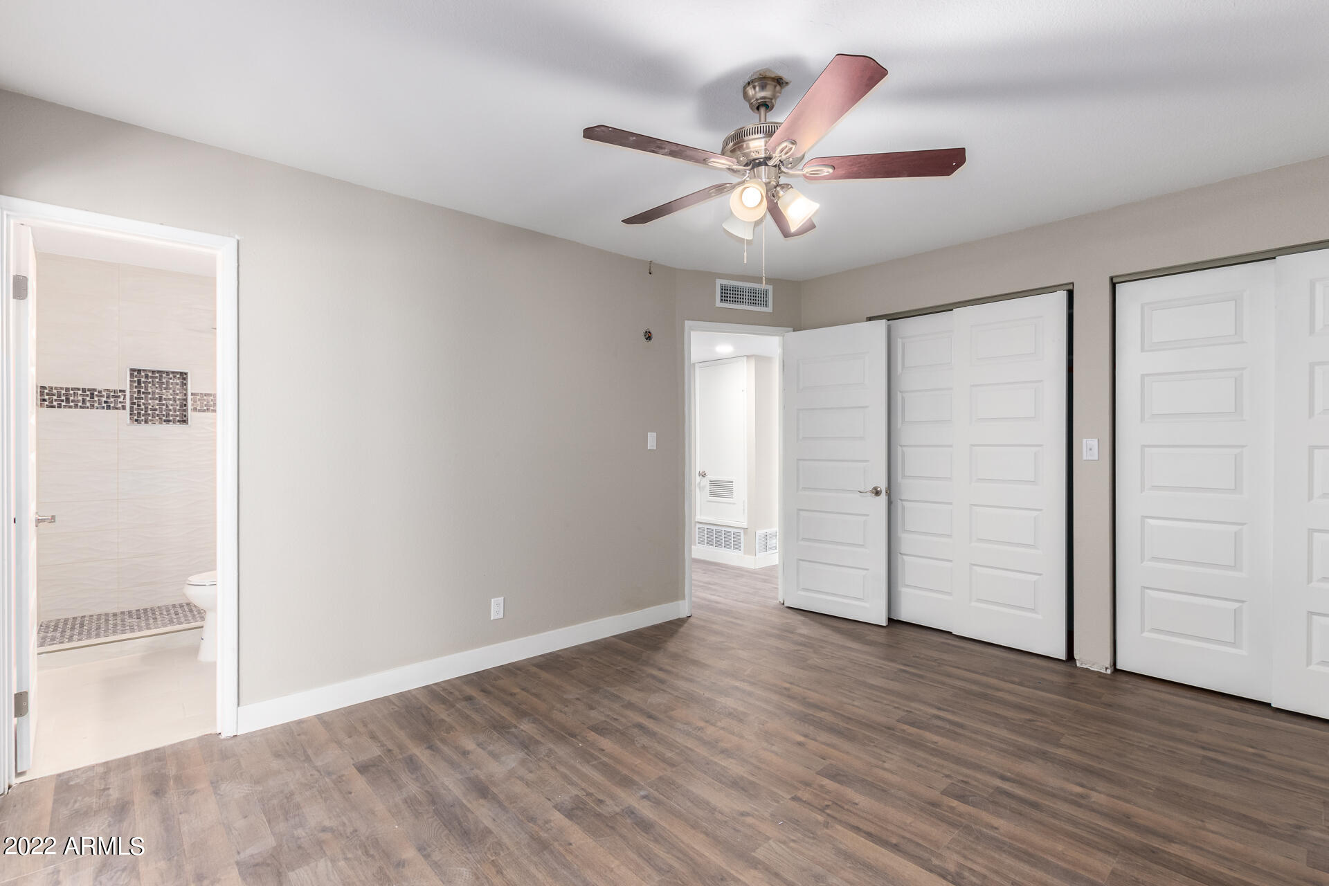 1036 East Butler Drive Phoenix, AZ 85020 - Photo 18 of 25 an empty room with wooden floor closet and fan