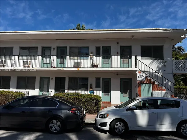 a front view of a house with parking space