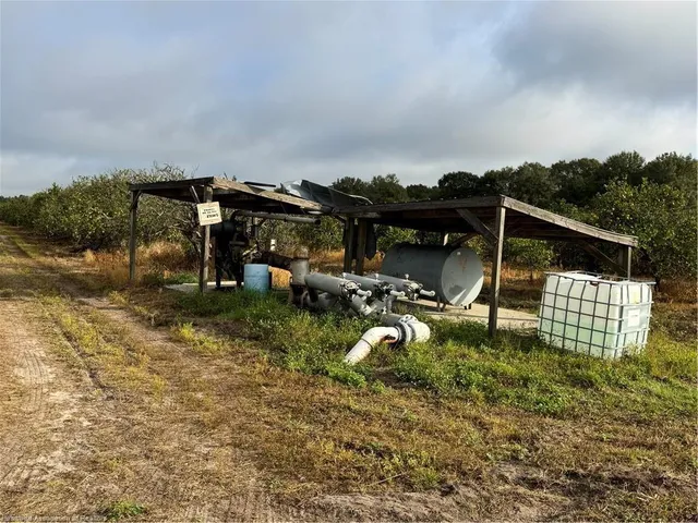 a backyard of a house with a fountain table and chairs