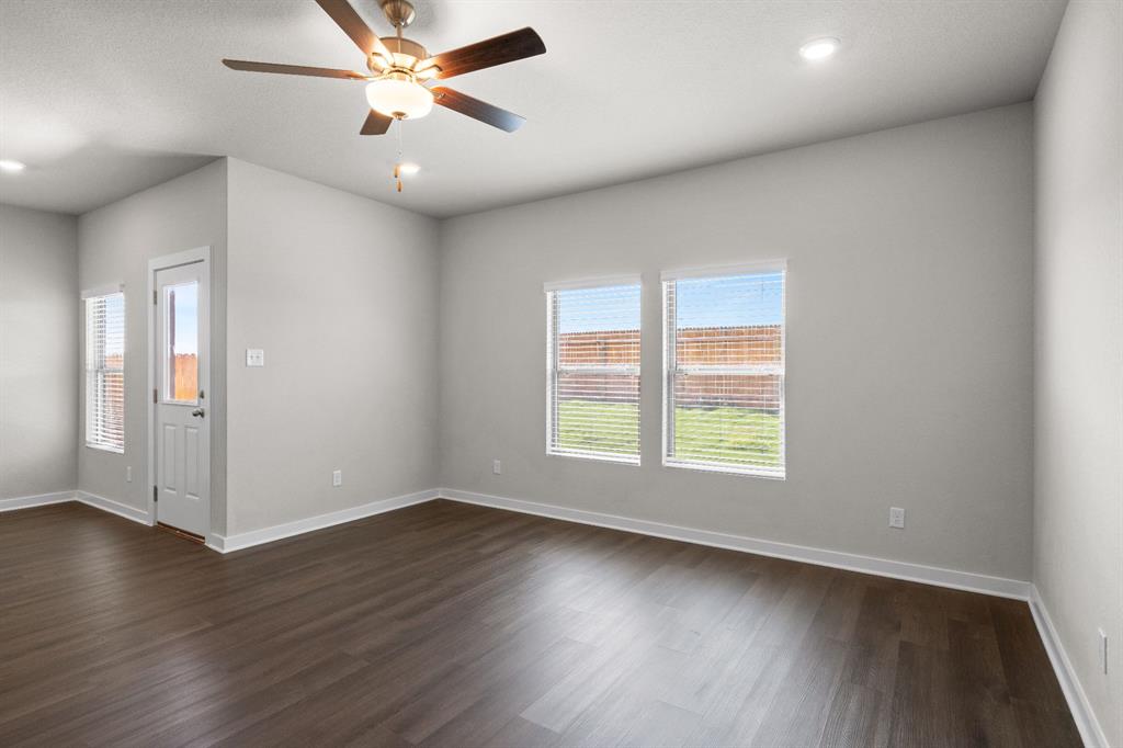 177 Sleep Hollow Jarrell, TX 76537 - Photo 11 of 24 Spacious room featuring wood-finish flooring, white baseboards, and light gray walls