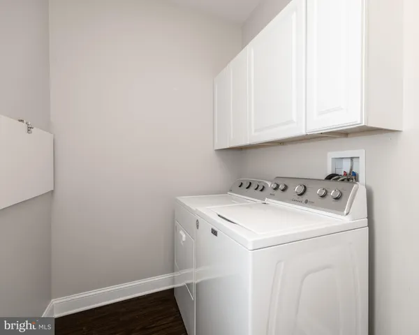 a bathroom with a sink vanity mirror and toilet