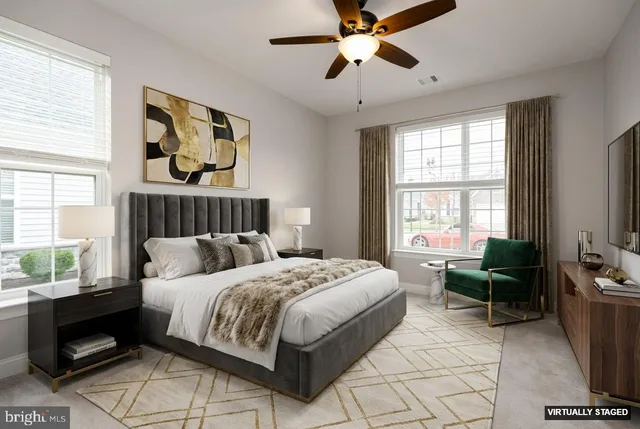 a black and white building with potted plants