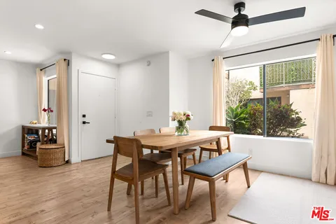 a view of a dining room with furniture window and wooden floor