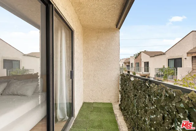 a view of balcony with a yard