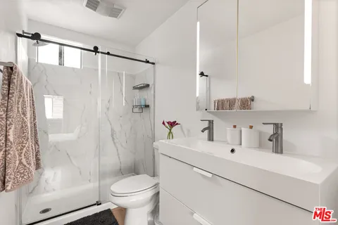 a bathroom with a sink toilet and shower