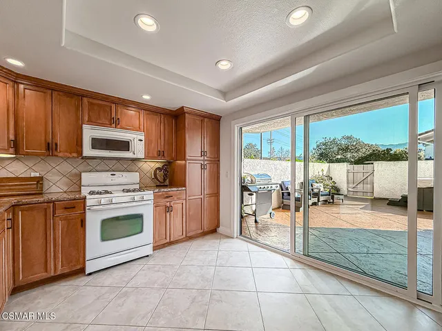a kitchen with a stove a sink and a microwave