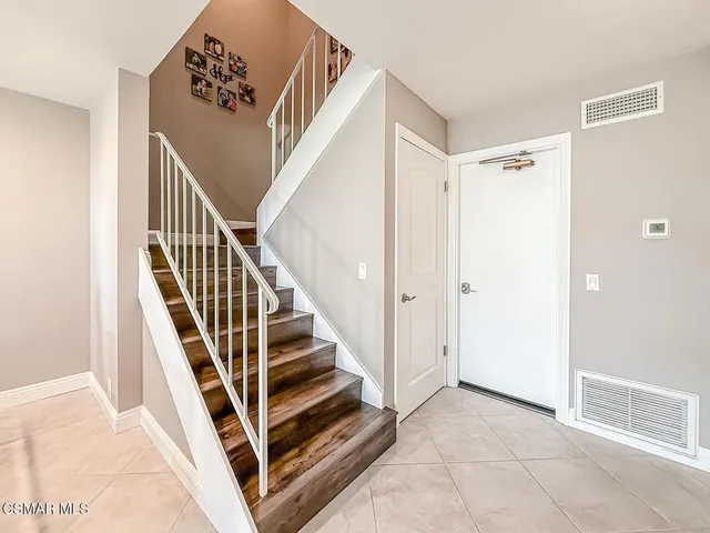 a view of a livingroom with furniture and staircase