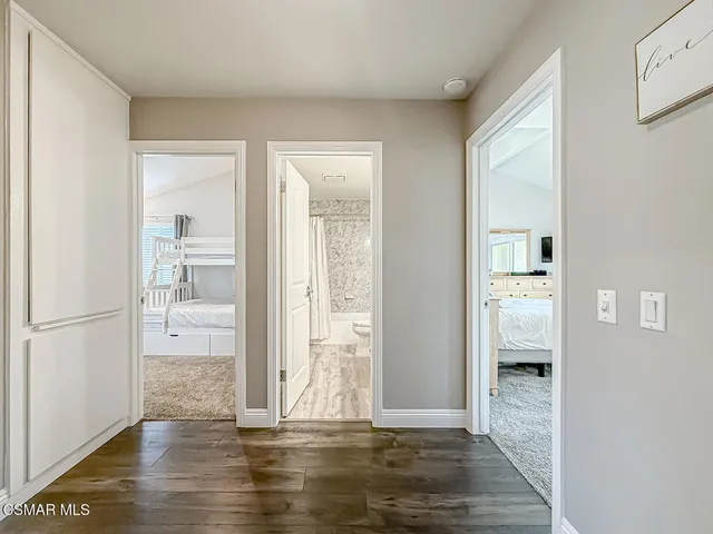 a view of a workspace with furniture and wooden floor