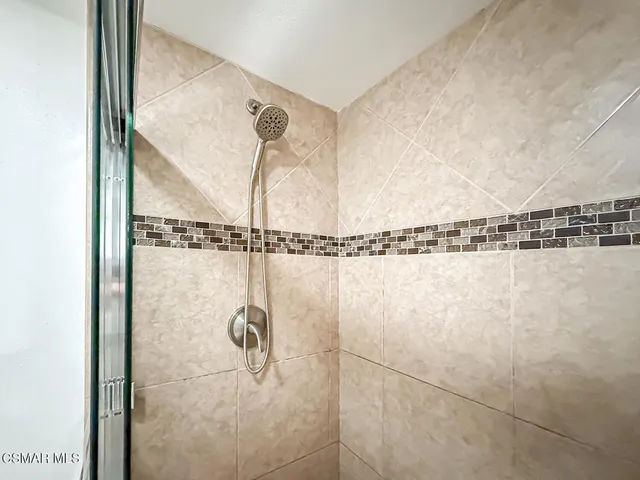 a view of walk in closet with clothes