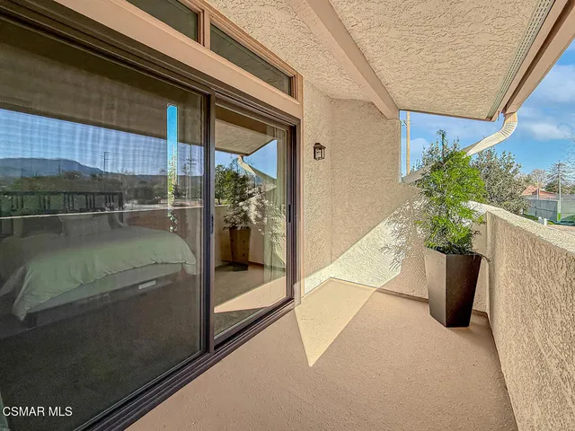a roof deck with couch and wooden floor