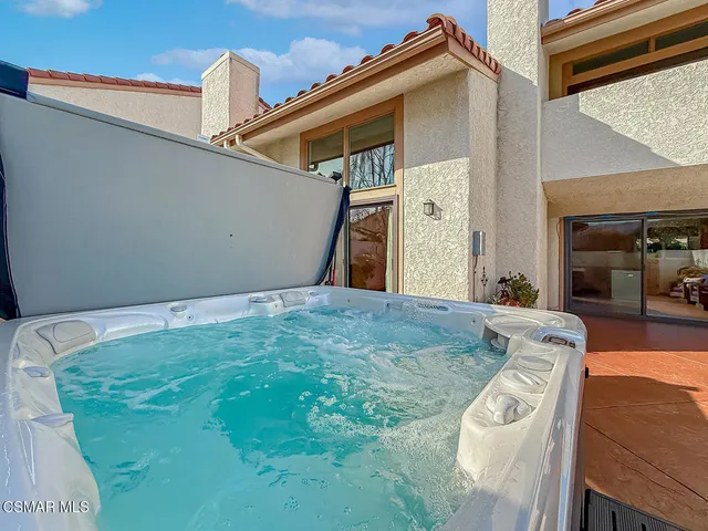 a view of a terrace with furniture and city view