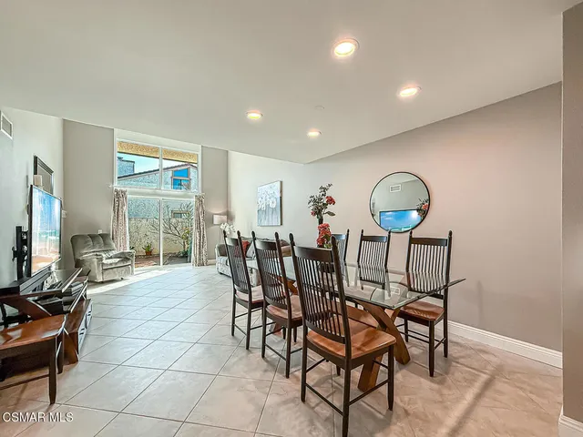 a view of a dining room with furniture and a window