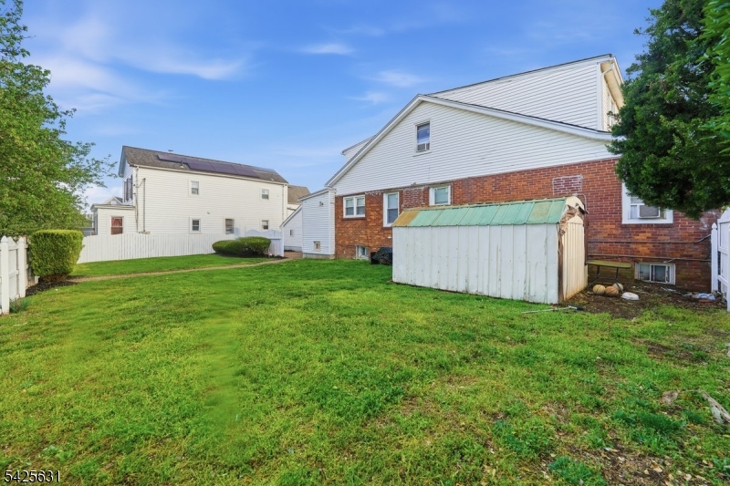 60 Westervelt Place Lodi, NJ 07644 - Photo 42 of 48 a backyard of a house with table and chairs