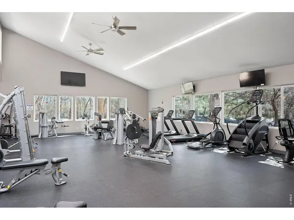 a view of a room with wooden floor and bench