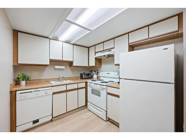 a white refrigerator freezer sitting in a kitchen
