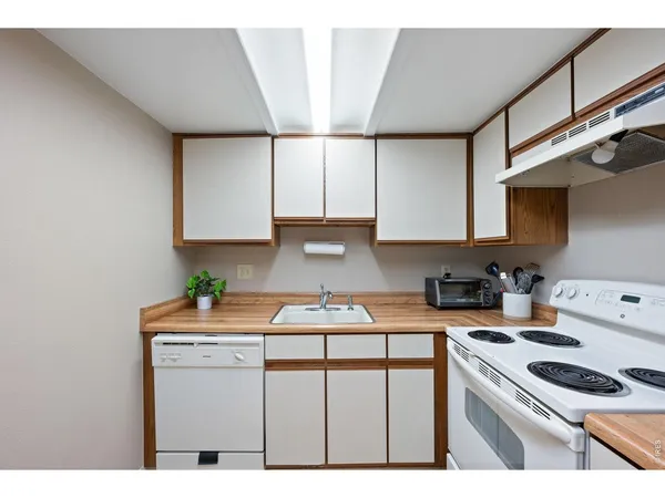 a kitchen with kitchen island a sink stove and cabinets