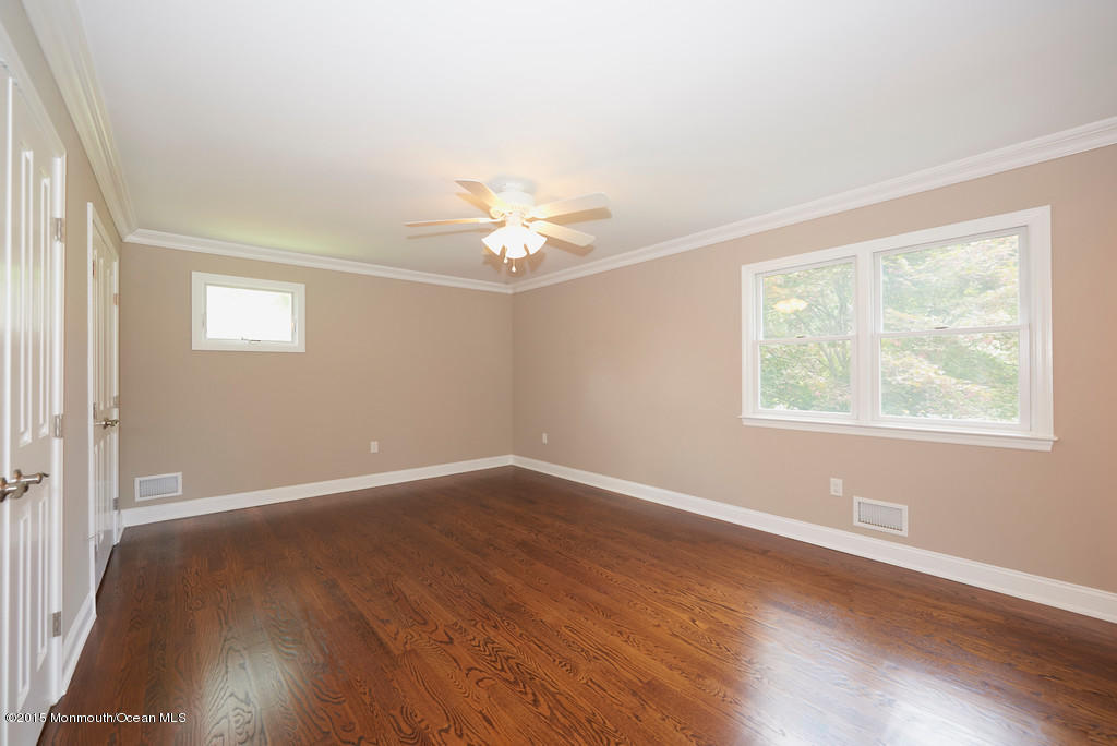 82 Kings Road Little Silver, NJ 07739 - Photo 14 of 19 a view of an empty room with wooden floor and a window