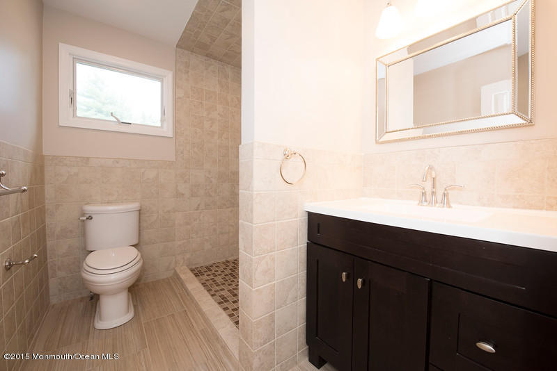 82 Kings Road Little Silver, NJ 07739 - Photo 15 of 19 a bathroom with a sink toilet a mirror and vanity