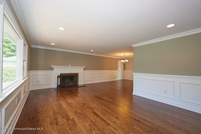 82 Kings Road Little Silver, NJ 07739 - Photo 4 of 19 an empty room with wooden floor and fireplace