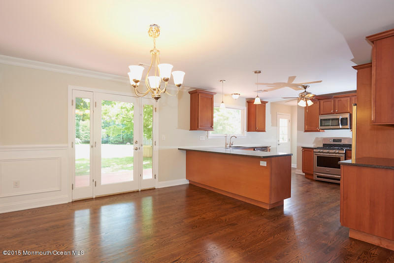 82 Kings Road Little Silver, NJ 07739 - Photo 6 of 19 a large kitchen with granite countertop a large window a sink and stainless steel appliances