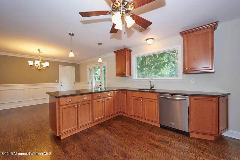 82 Kings Road Little Silver, NJ 07739 - Photo 8 of 19 a kitchen with stainless steel appliances granite countertop wooden cabinets a dining table and chairs