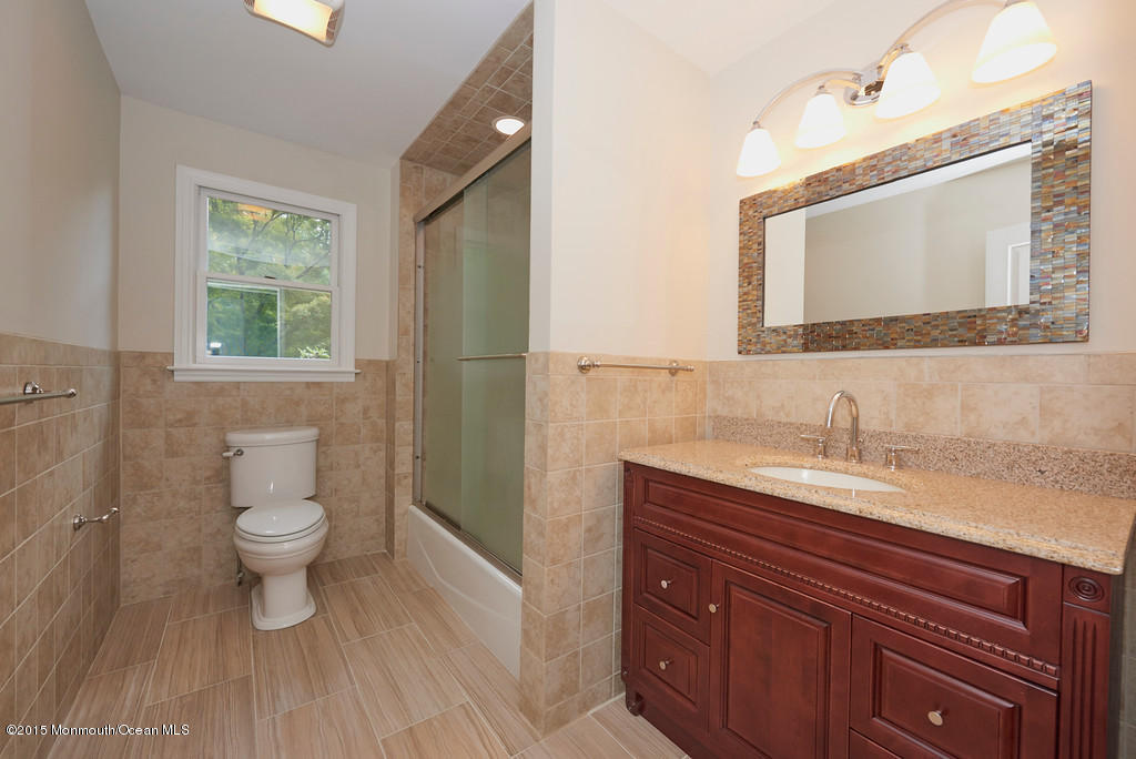 82 Kings Road Little Silver, NJ 07739 - Photo 9 of 19 a bathroom with a granite countertop sink a toilet and a mirror