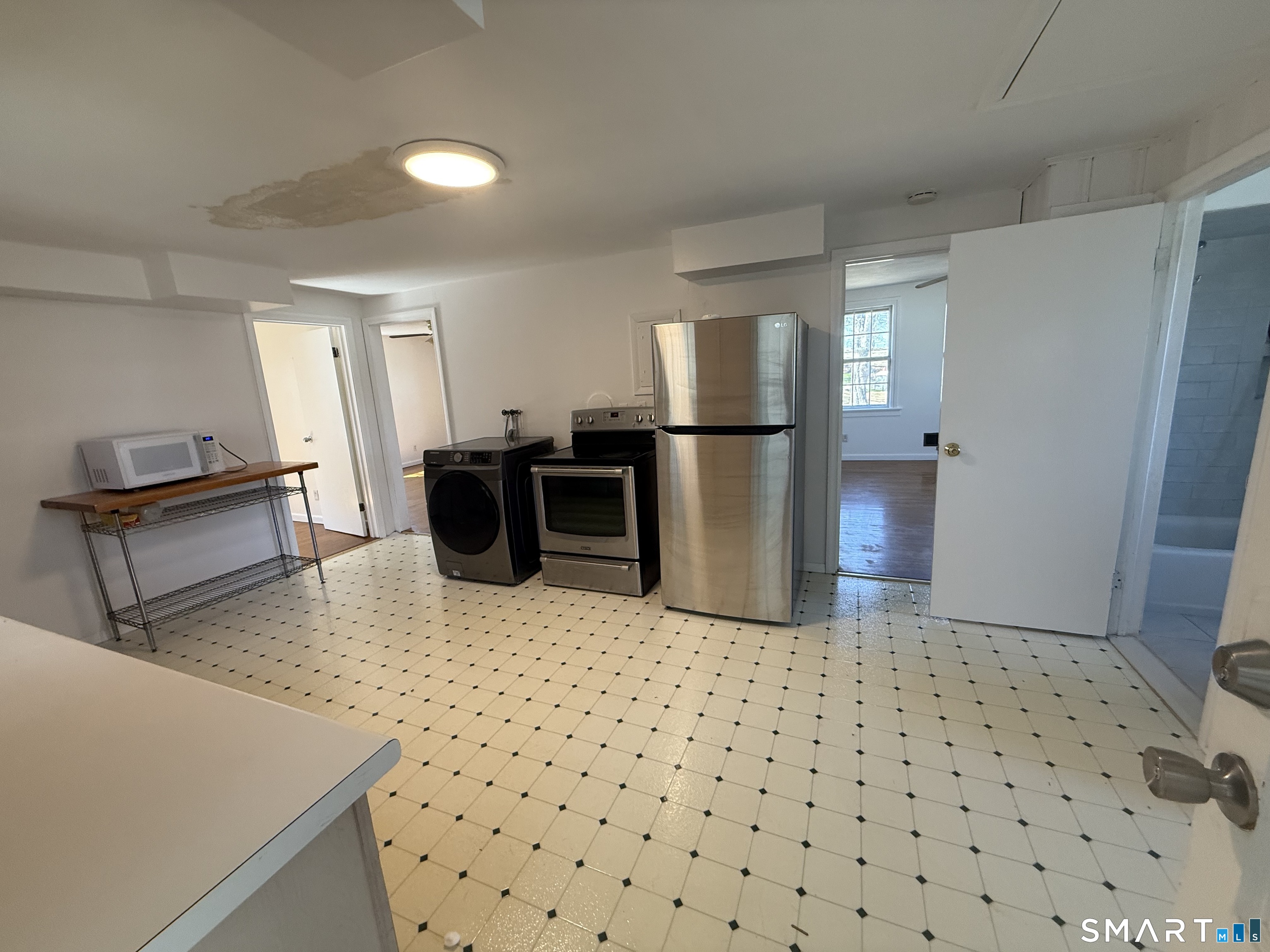 29 North Hill Road North Haven, CT 06473 - Photo 7 of 14 a kitchen with a sink a refrigerator and a stove top oven