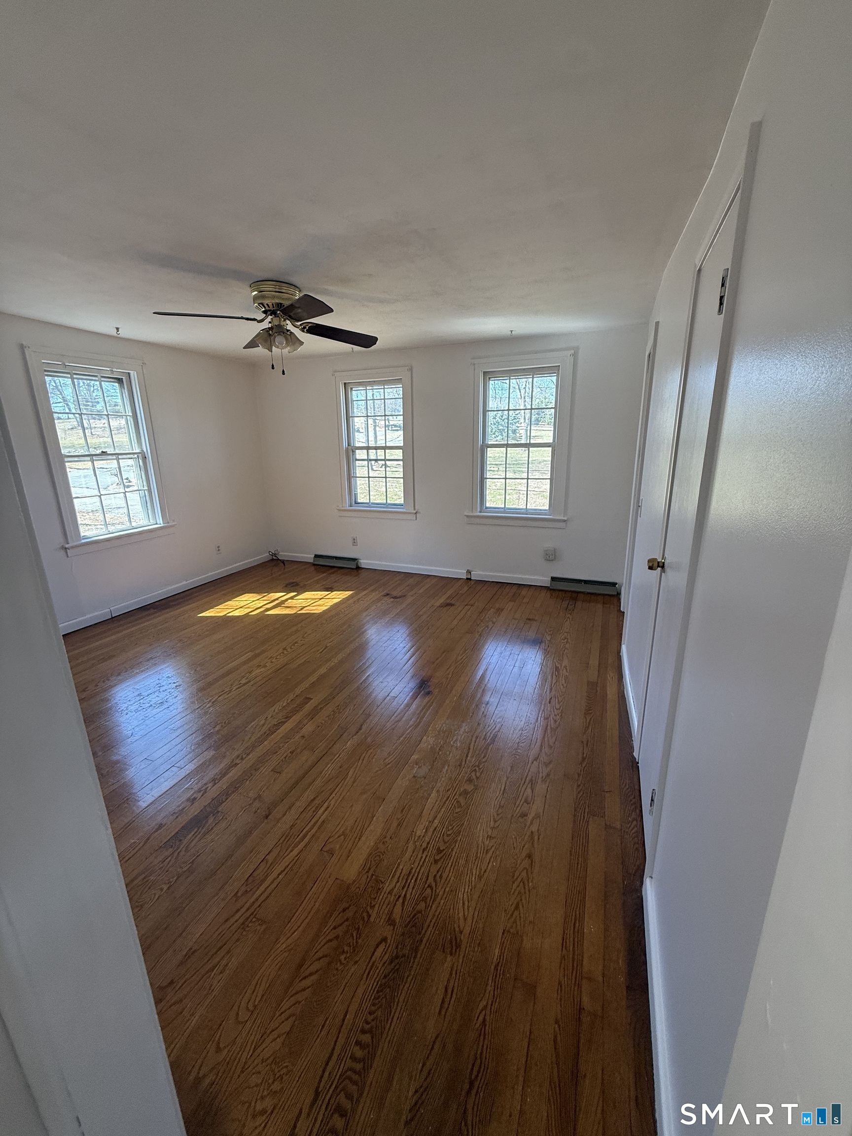 29 North Hill Road North Haven, CT 06473 - Photo 10 of 14 a view of empty room with wooden floor and fan